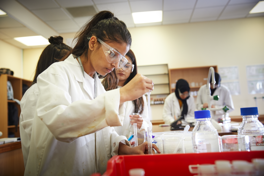 a picture of a student doing a science experiment in class