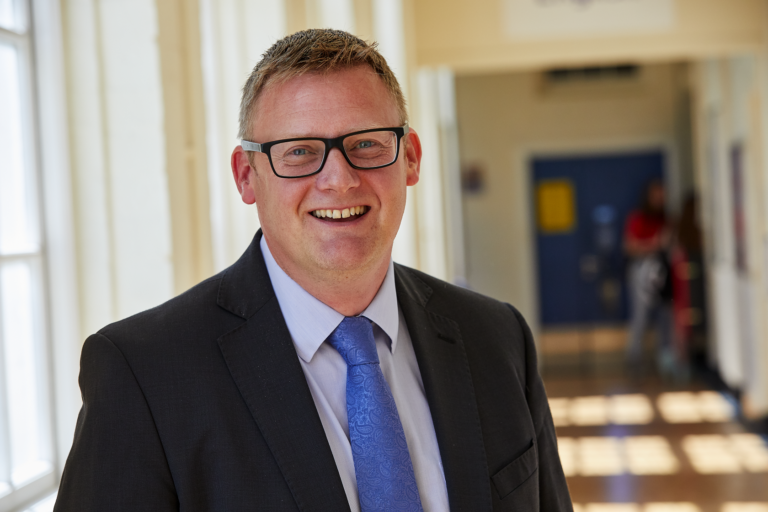 photo of WQE headmaster Paul Wilson in school corridor