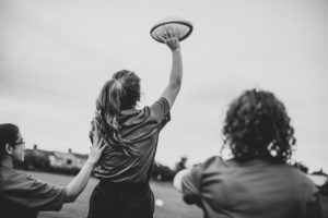a close up of a student catching a rugby ball