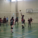 Students competing a volleyball match during enrichment.