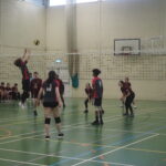 Students competing a volleyball match during enrichment.